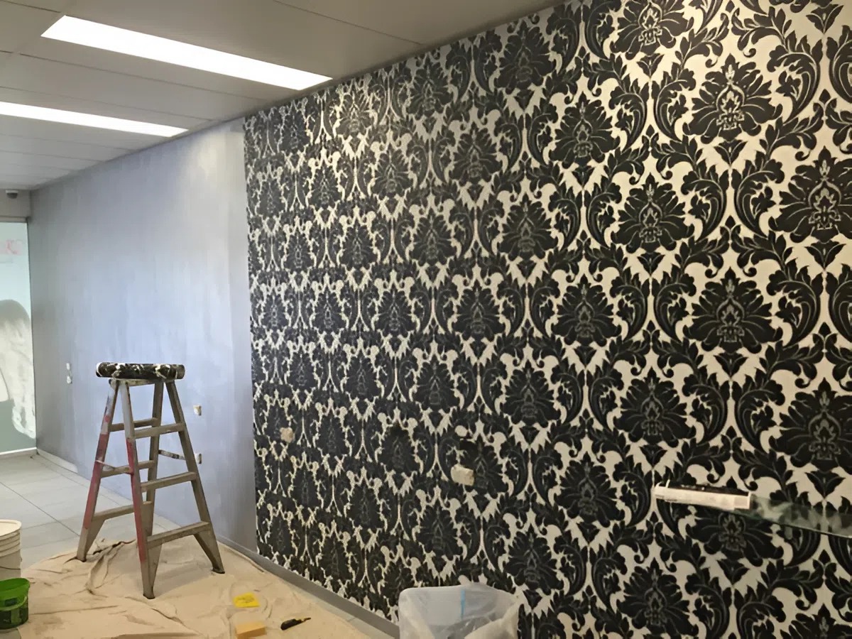 Wall finished with bold patterned wallpaper by a professional painter in Des Moines, IA