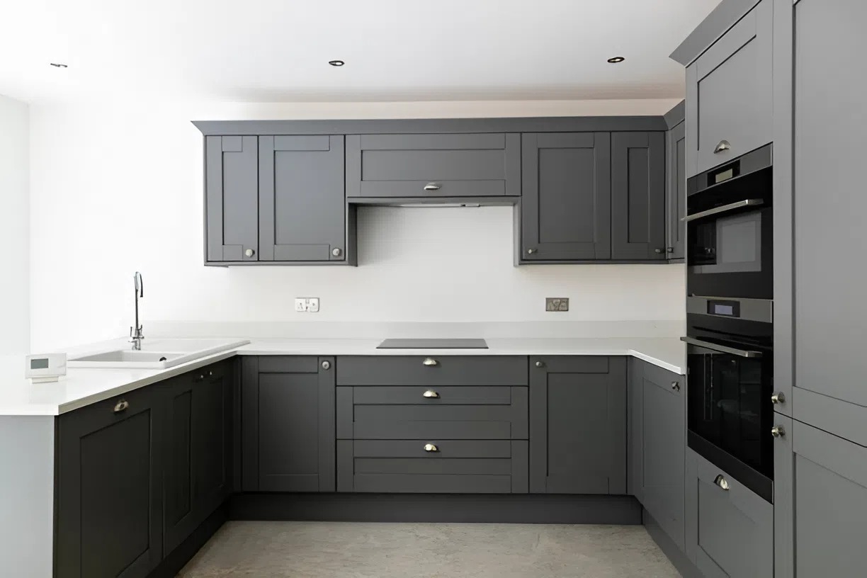 Modern gray kitchen cabinets freshly painted by a professional interior painter in Waukee, IA.