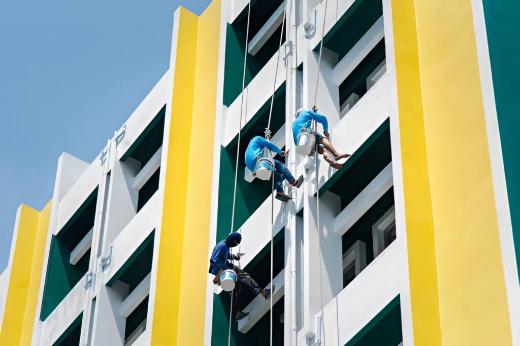 Commercial building with freshly painted vertical surfaces in white and yellow by a painter in Ames, IA